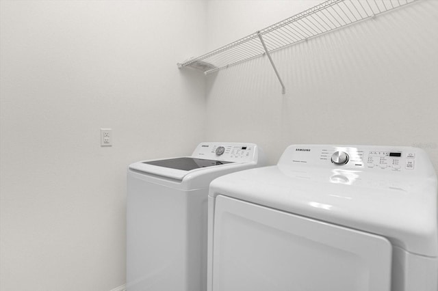 washroom with washer and dryer