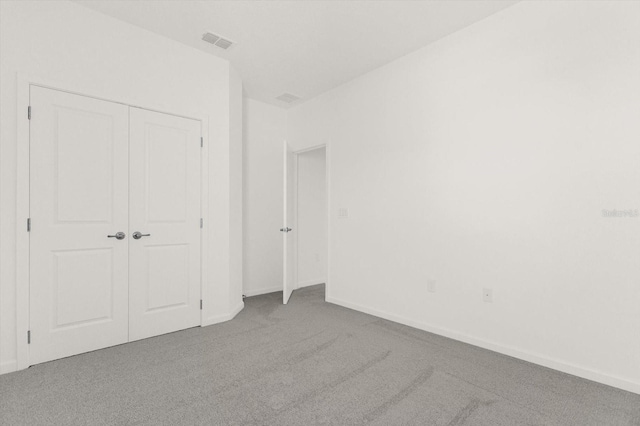 unfurnished bedroom featuring a closet and carpet flooring