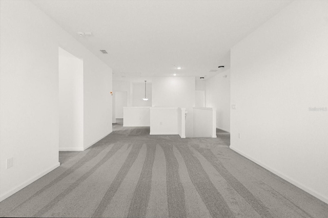 unfurnished room featuring light carpet