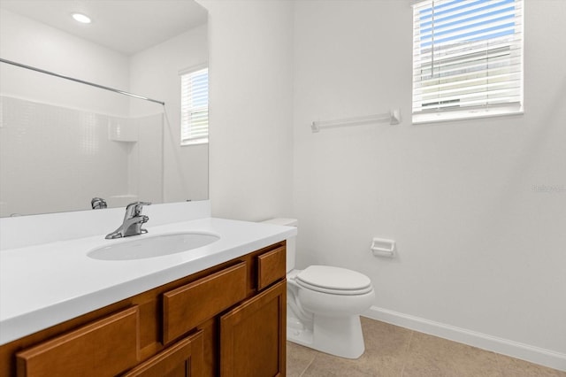 bathroom featuring vanity, toilet, and tile patterned flooring