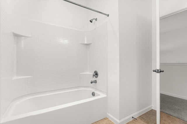 bathroom with shower / washtub combination and tile patterned floors