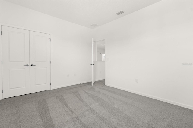 unfurnished bedroom with carpet and a closet