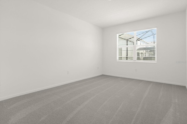 unfurnished room with carpet flooring