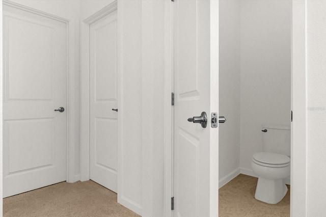 bathroom with tile patterned floors and toilet