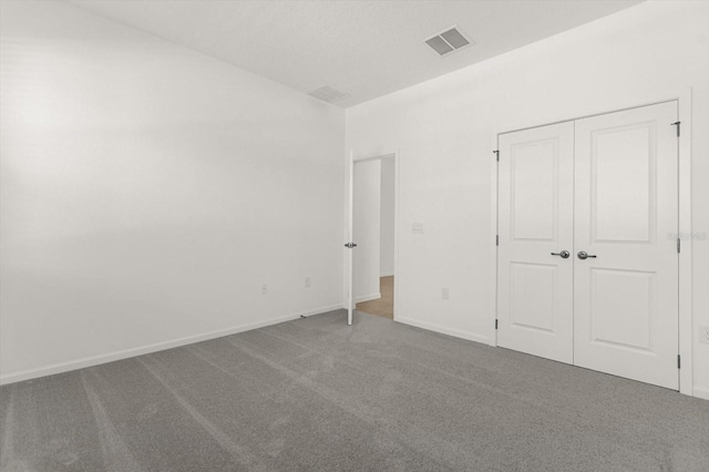 unfurnished bedroom featuring a closet and carpet flooring