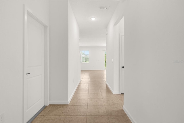 corridor with light tile patterned floors