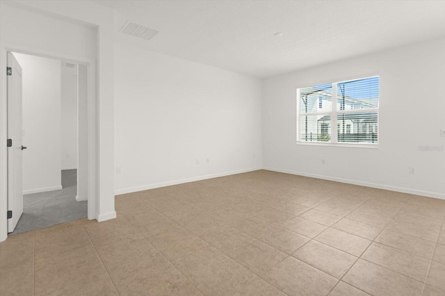 spare room featuring light tile patterned flooring