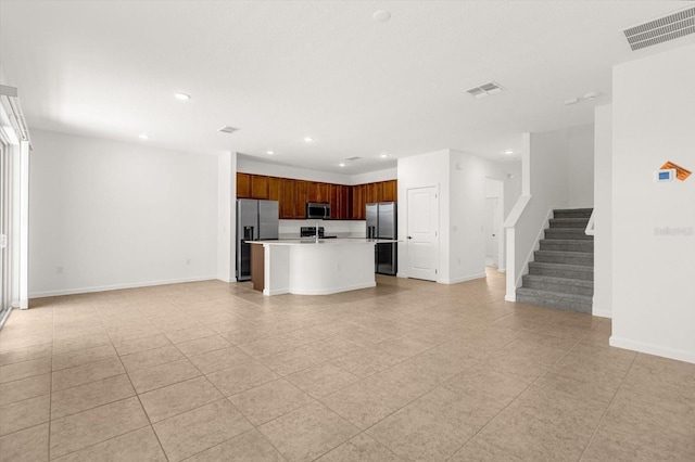 unfurnished living room featuring sink and light tile patterned floors