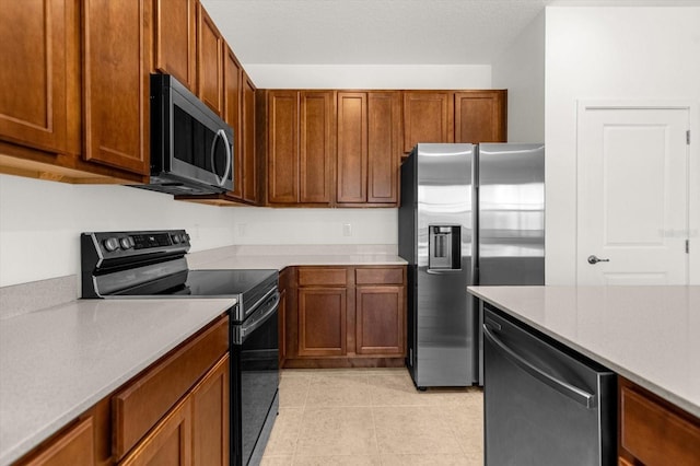 kitchen with stainless steel appliances and light tile patterned floors