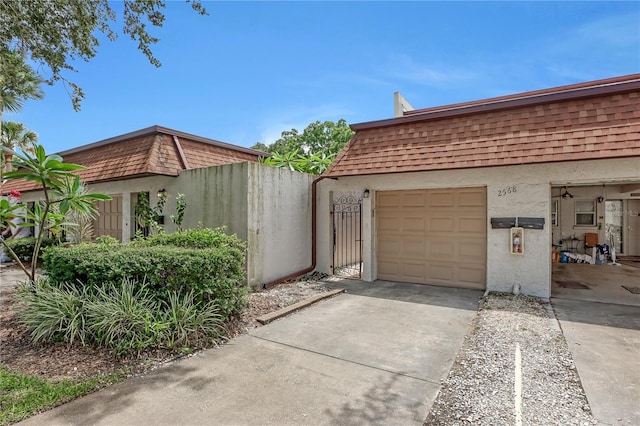 view of side of home with a garage and an outbuilding