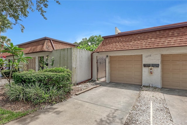 view of side of home featuring a garage and an outdoor structure