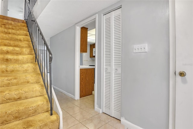 stairway featuring tile patterned flooring