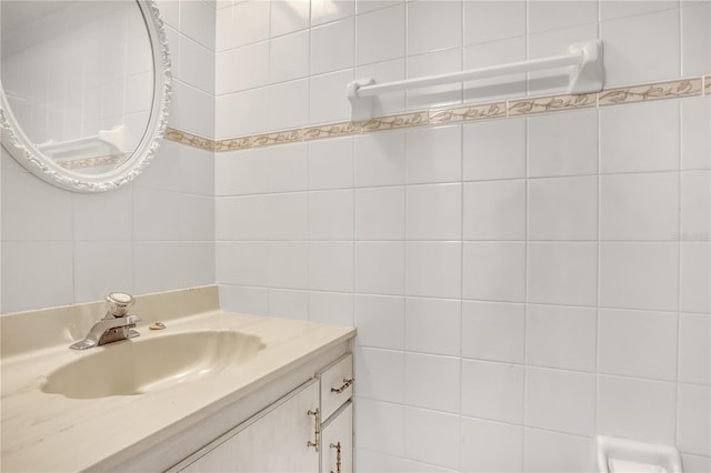 bathroom featuring vanity and tile walls