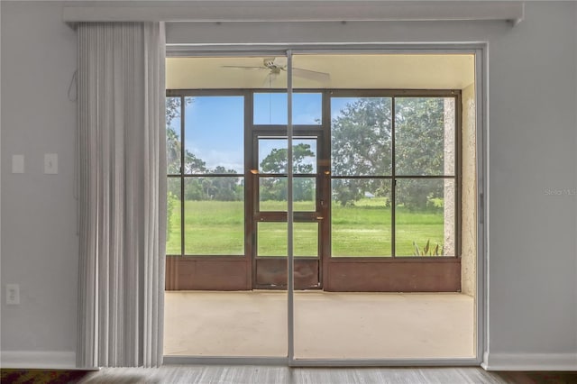 doorway to outside with a wealth of natural light and ceiling fan