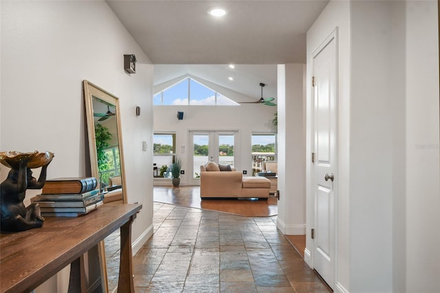 hall featuring high vaulted ceiling and french doors