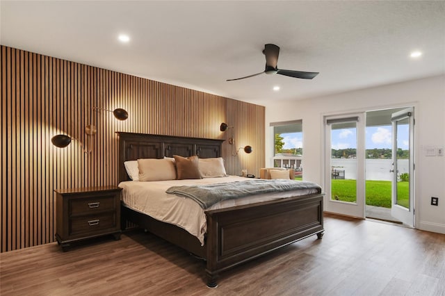 bedroom with wood-type flooring, access to exterior, and ceiling fan