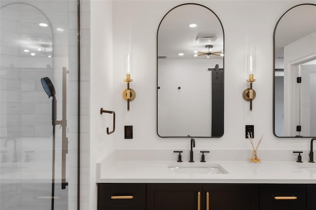 bathroom featuring vanity and a shower with door