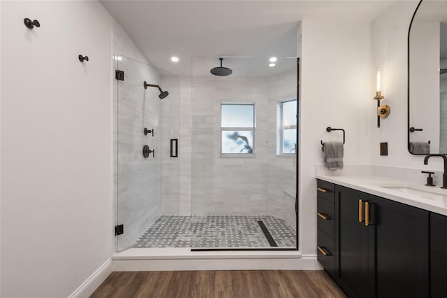 bathroom with vanity, hardwood / wood-style flooring, and walk in shower