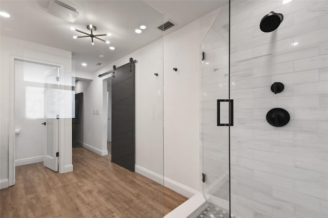 bathroom featuring hardwood / wood-style flooring and a shower with door