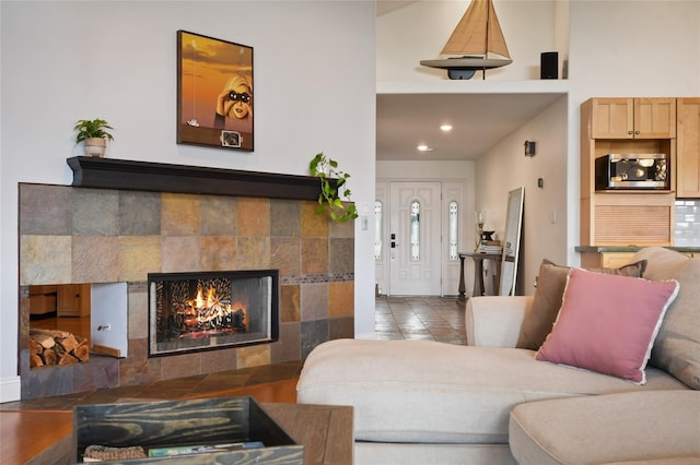 tiled living room featuring a tiled fireplace