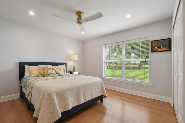 bedroom with hardwood / wood-style floors and ceiling fan