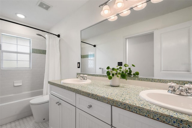 full bathroom with tile patterned flooring, vanity, shower / bath combo with shower curtain, and toilet