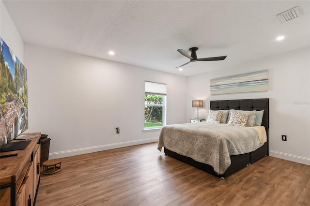 bedroom with ceiling fan and hardwood / wood-style floors