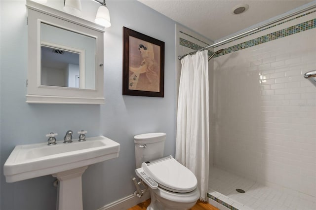 bathroom featuring sink, toilet, and walk in shower