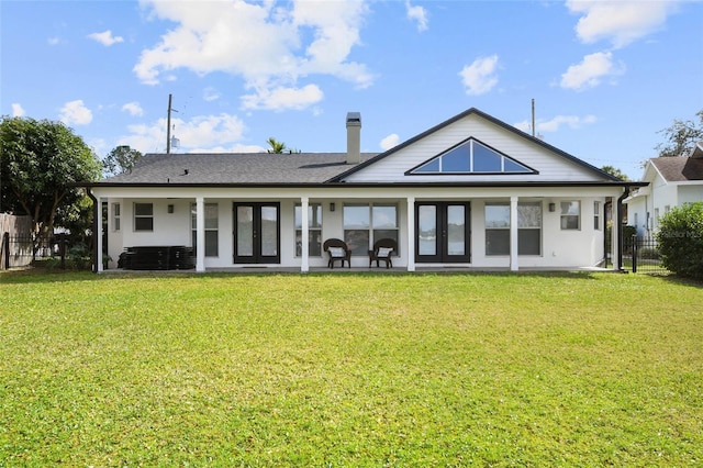 back of house with a lawn and french doors