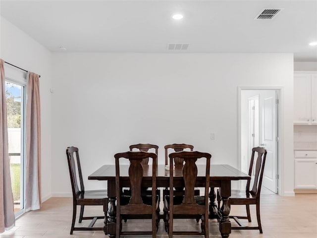 dining space with light hardwood / wood-style floors