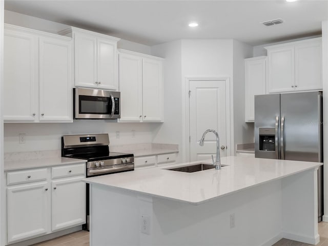 kitchen featuring an island with sink, appliances with stainless steel finishes, and sink