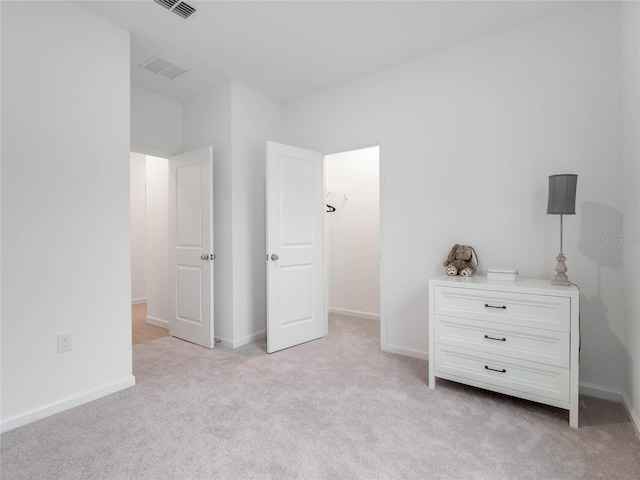 unfurnished bedroom featuring light carpet