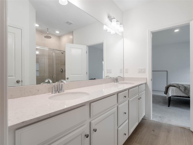 bathroom featuring a shower with door, wood-type flooring, and vanity