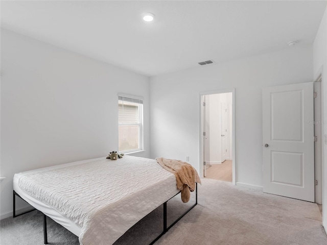 bedroom featuring light colored carpet