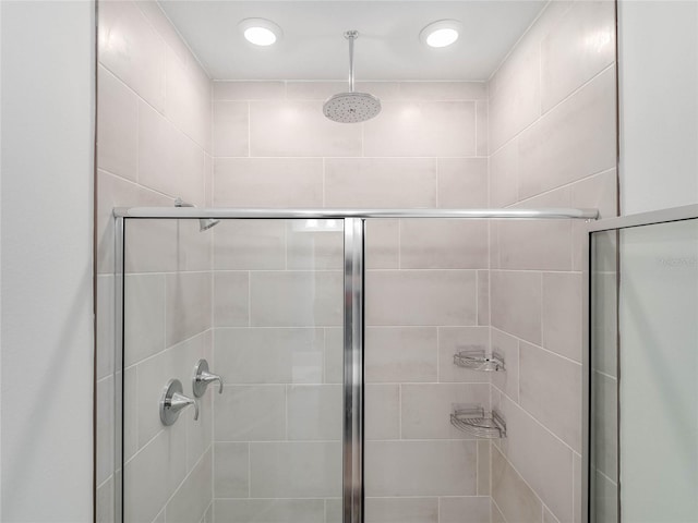 bathroom with a shower with door