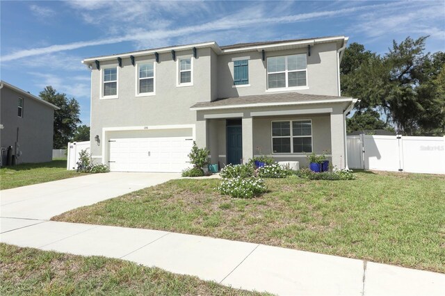 view of front of home featuring a garage and a front lawn