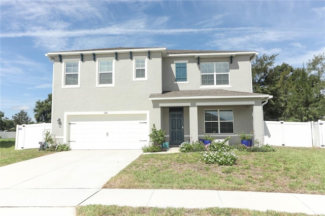 view of front of property featuring a garage and a front yard