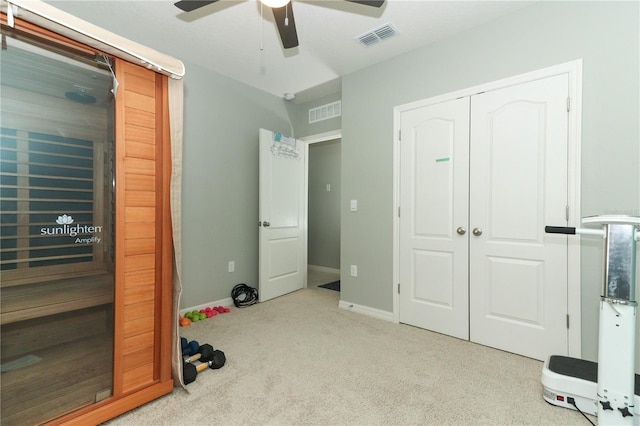 interior space with light colored carpet and ceiling fan