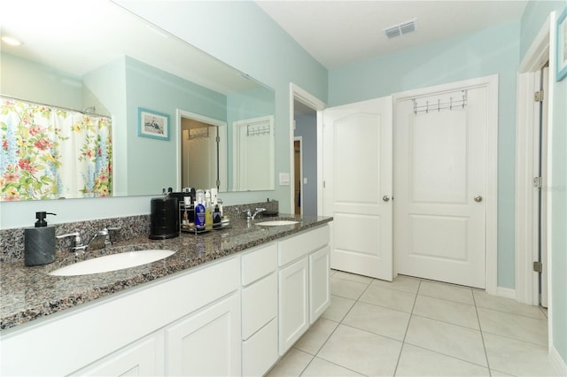 bathroom featuring double vanity and tile patterned floors