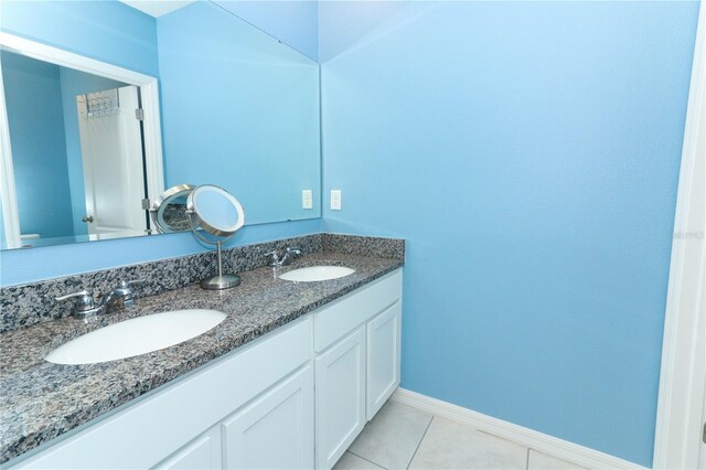 bathroom featuring tile patterned flooring and double sink vanity