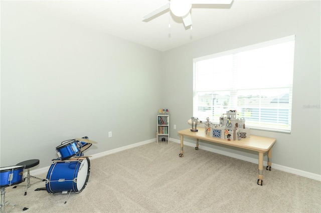 miscellaneous room featuring light colored carpet and ceiling fan