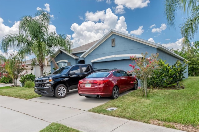 view of front of house with a front yard and a garage