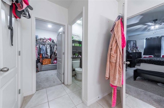 bathroom with toilet and tile patterned flooring