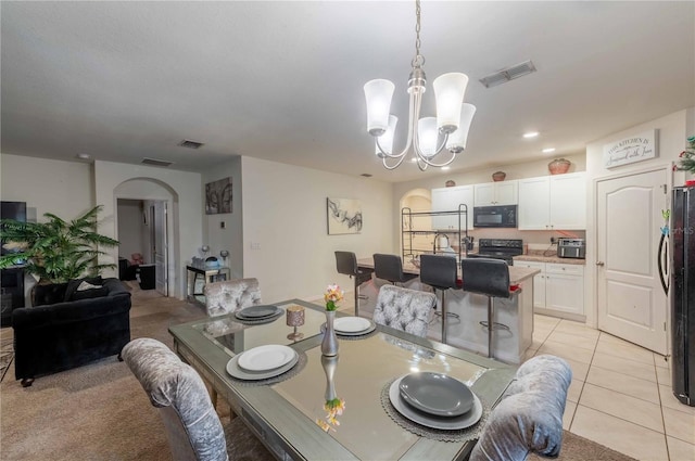 tiled dining space with a chandelier