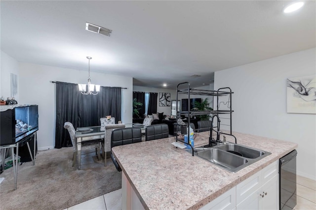 kitchen with light tile patterned floors, sink, dishwasher, and white cabinetry