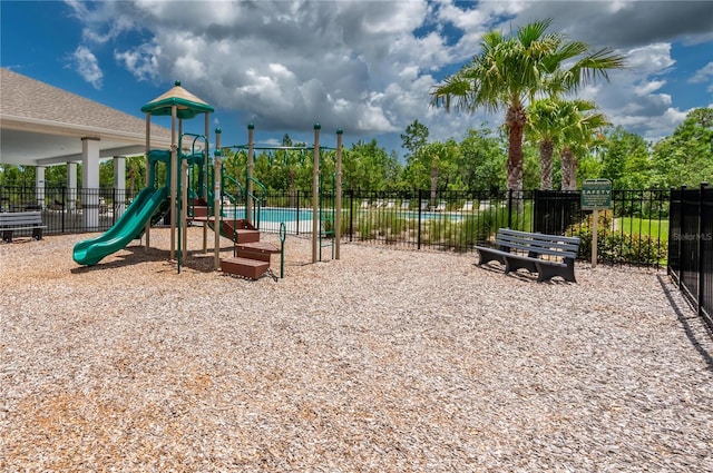 view of playground featuring a community pool