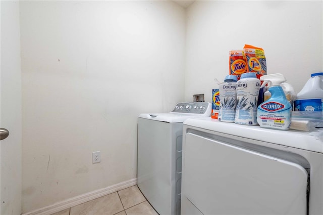 laundry room with light tile patterned flooring and separate washer and dryer