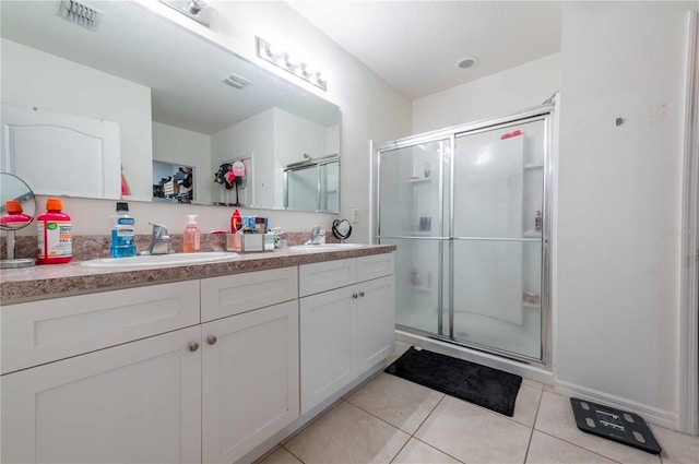 bathroom featuring walk in shower, dual bowl vanity, and tile patterned flooring