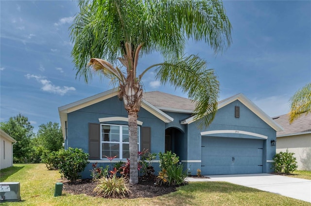 2950 Gibraltar Blvd, New Smyrna Beach, FL 32168 - view of front of house featuring stucco siding, a garage, and a front yard