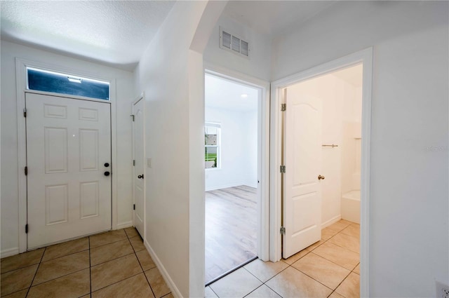 2950 Gibraltar Blvd, New Smyrna Beach, FL 32168 - foyer entrance featuring light tile patterned flooring, arched walkways, and visible vents